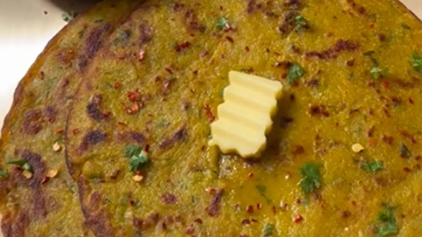 Liquid aloo paratha being cooked on tawa with golden crisp edges 5